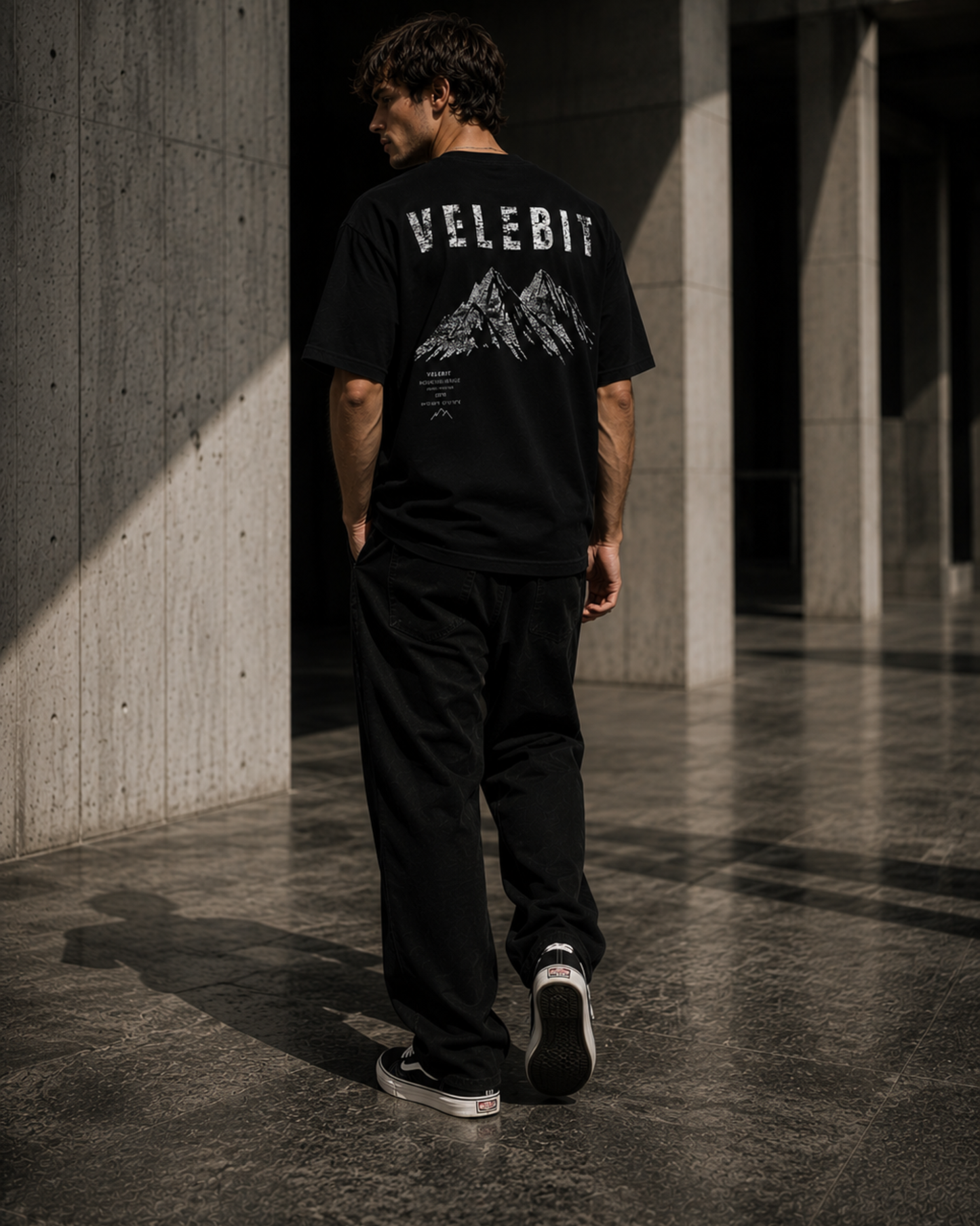 Model wearing ZeroCore Velebit t-shirt in a minimalist outdoor editorial setting