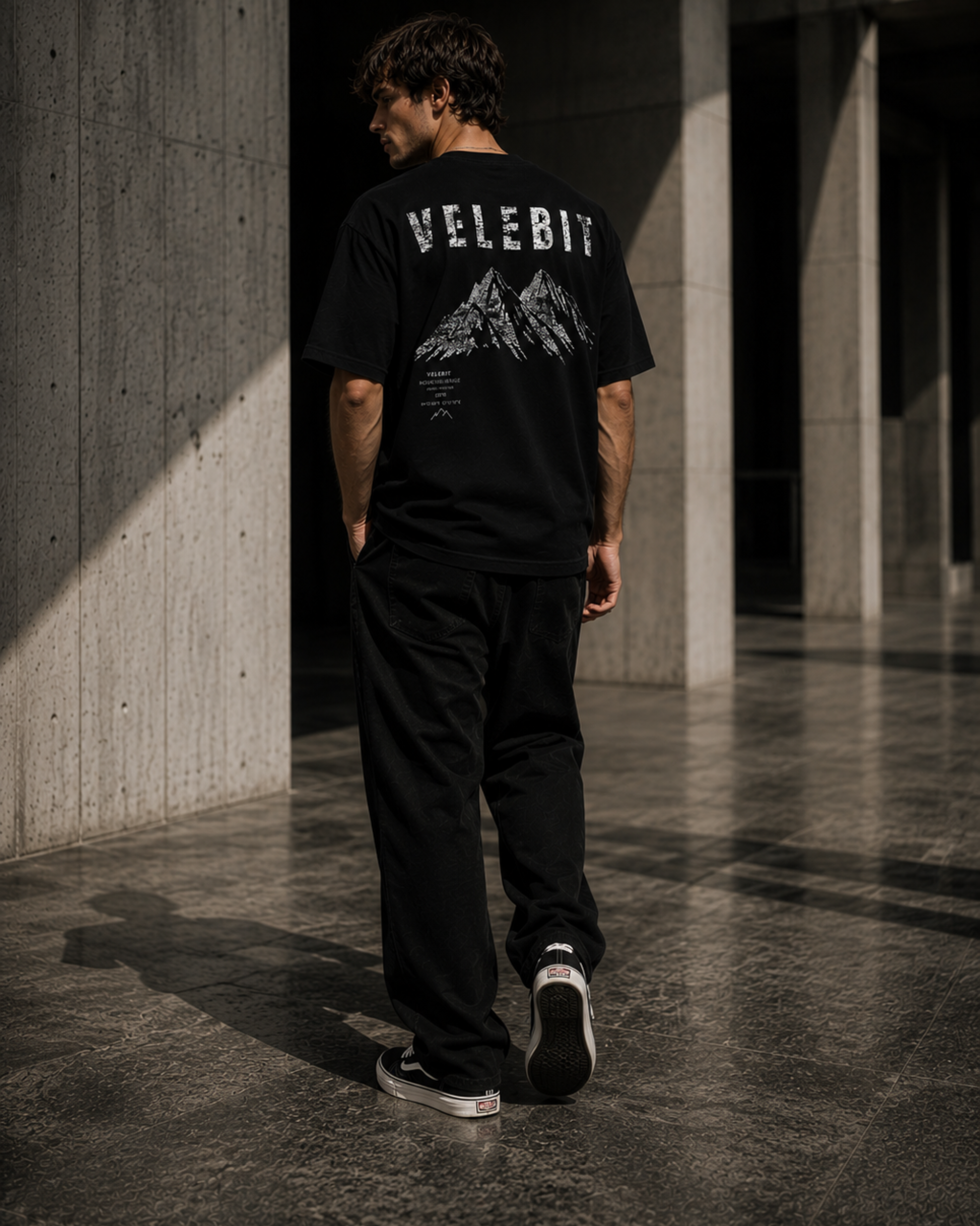 Model wearing ZeroCore Velebit t-shirt in a minimalist outdoor editorial setting